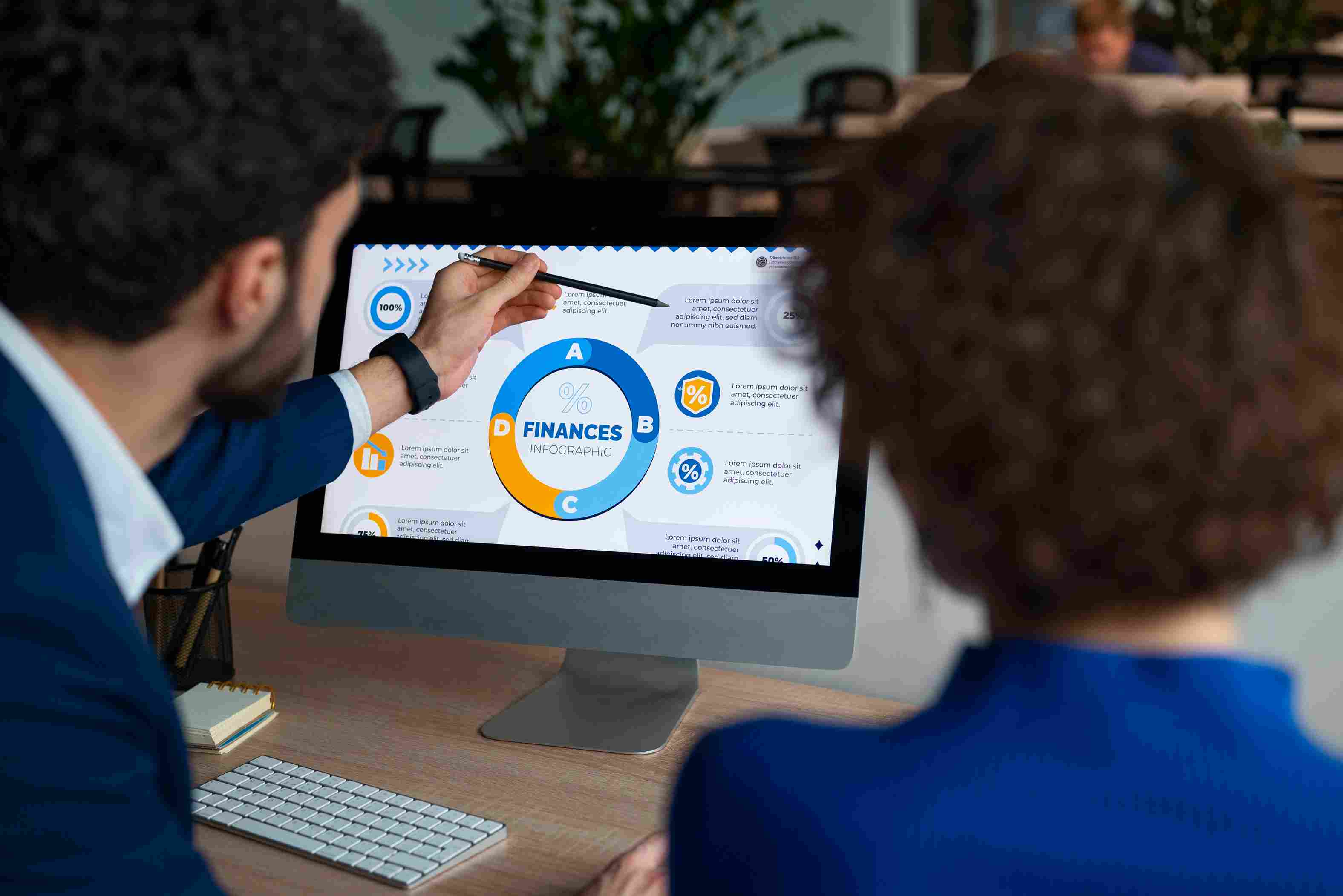 Team reviewing financial graphs on a desktop, illustrating analysis and optimization in healthcare revenue cycle processes.