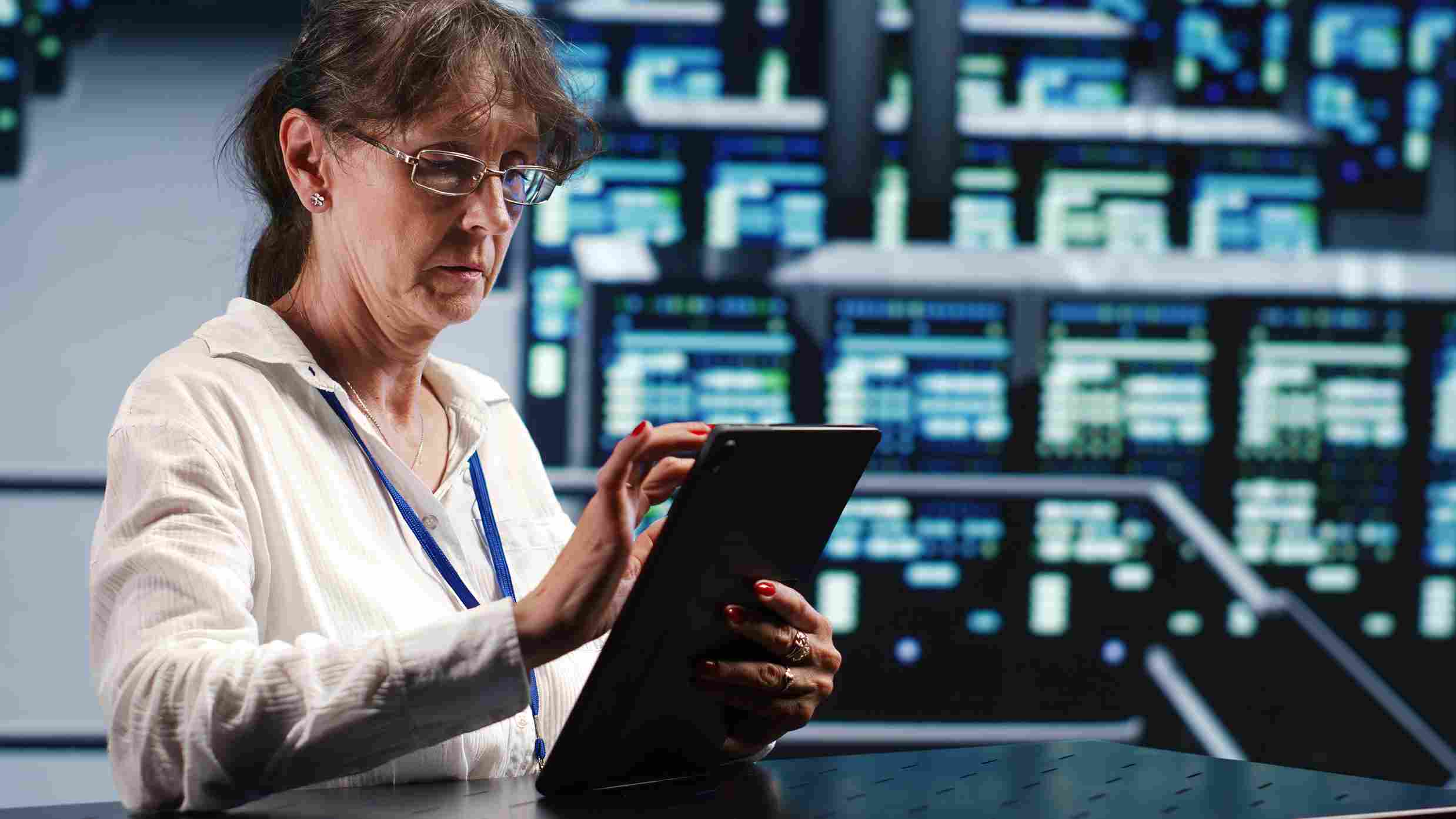 Medical staff using tablet with data servers in background
