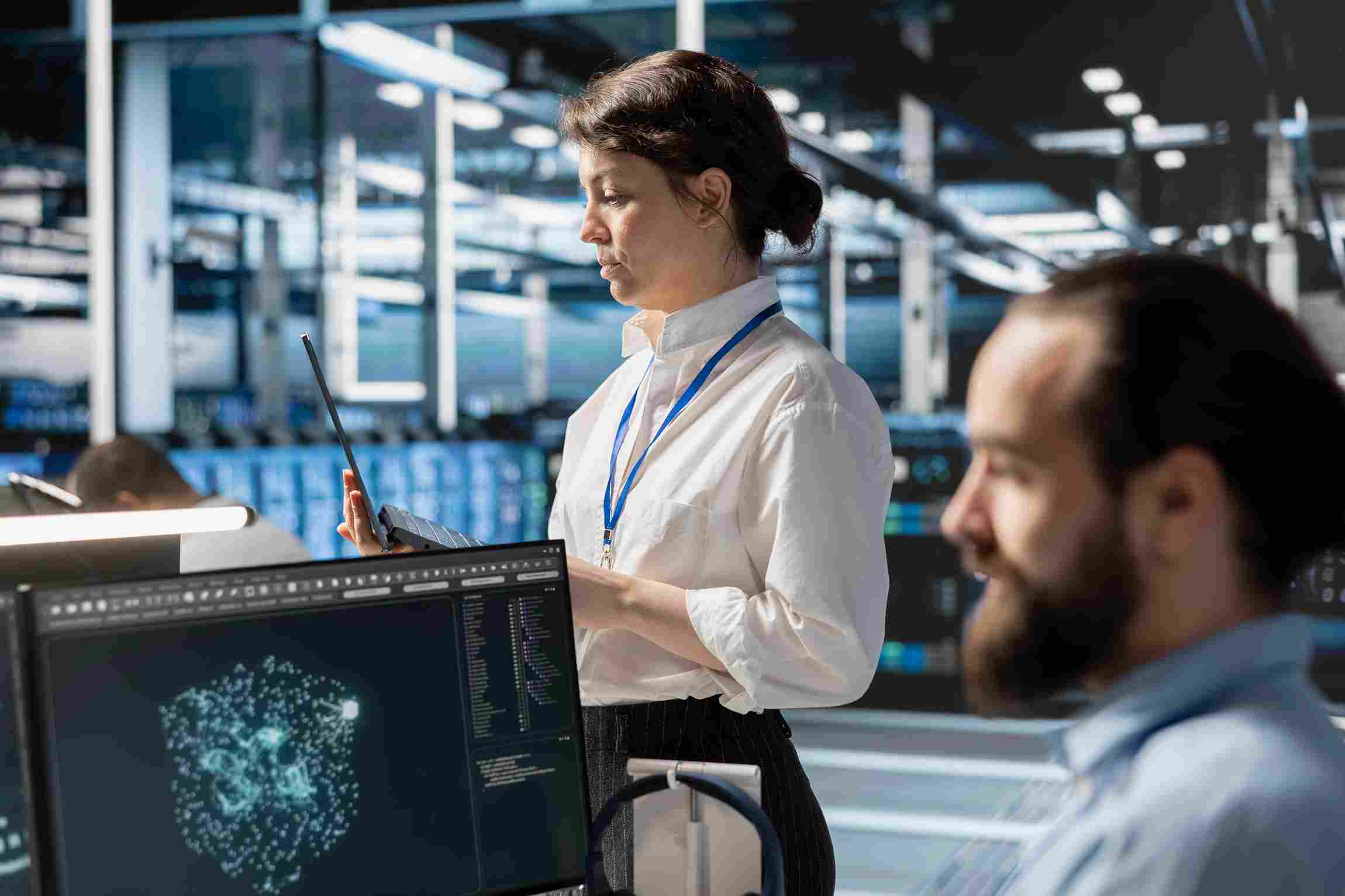 Healthcare professionals analyzing patient data on laptops in a cloud-enabled facility.