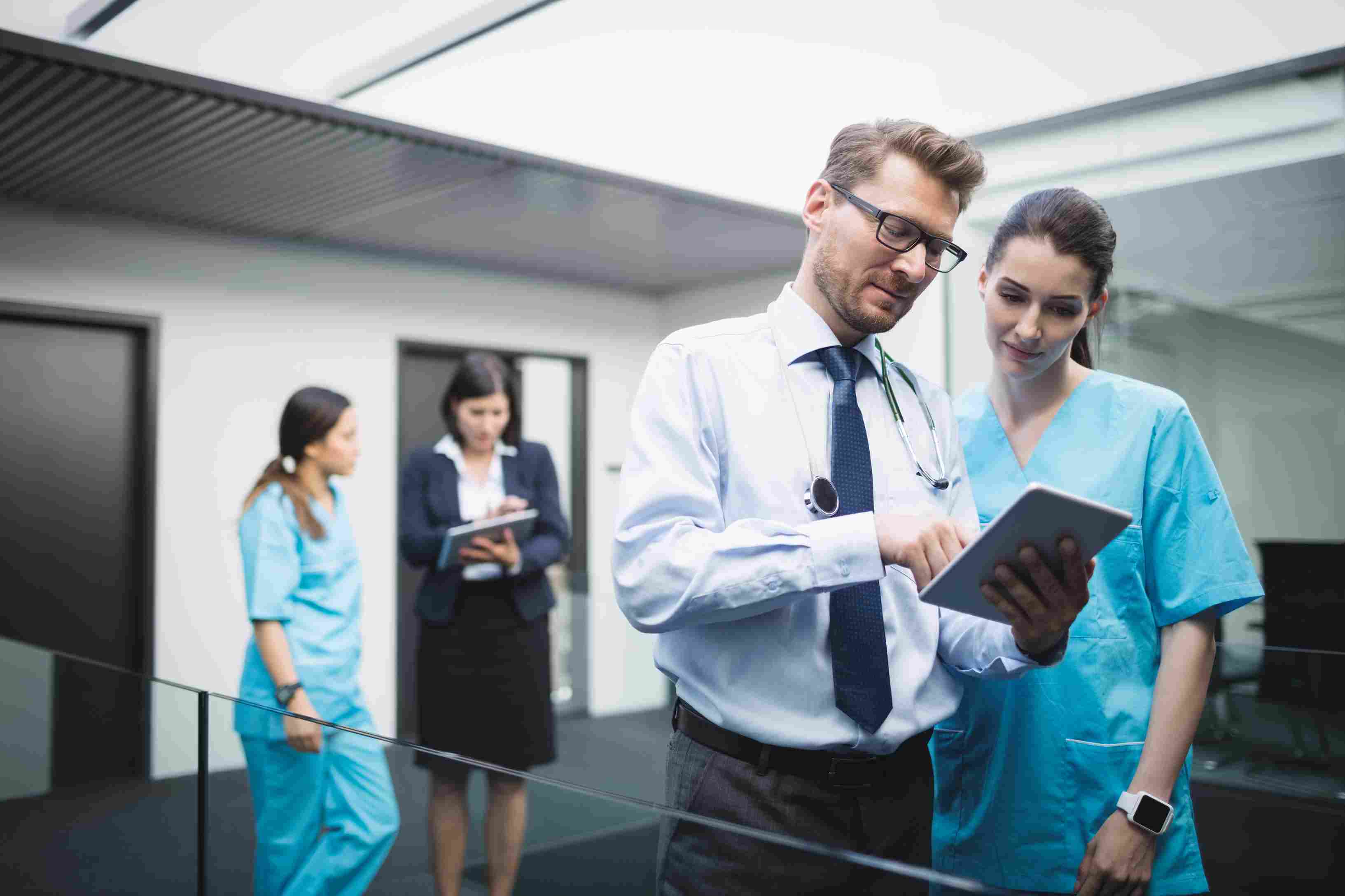 a doctor and a nurse checking out some patient reports