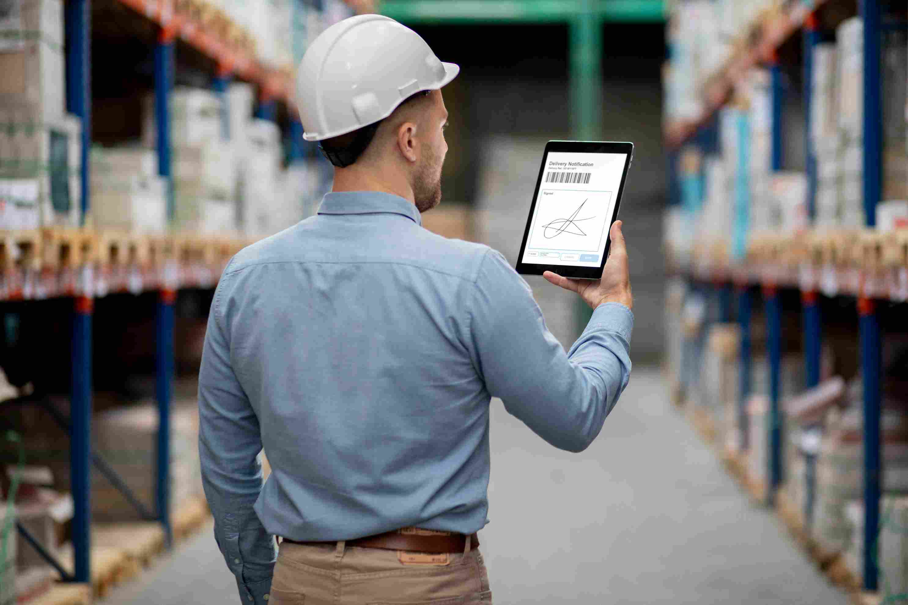 Illustration of a worker entering inventory data on a tablet with boxes around