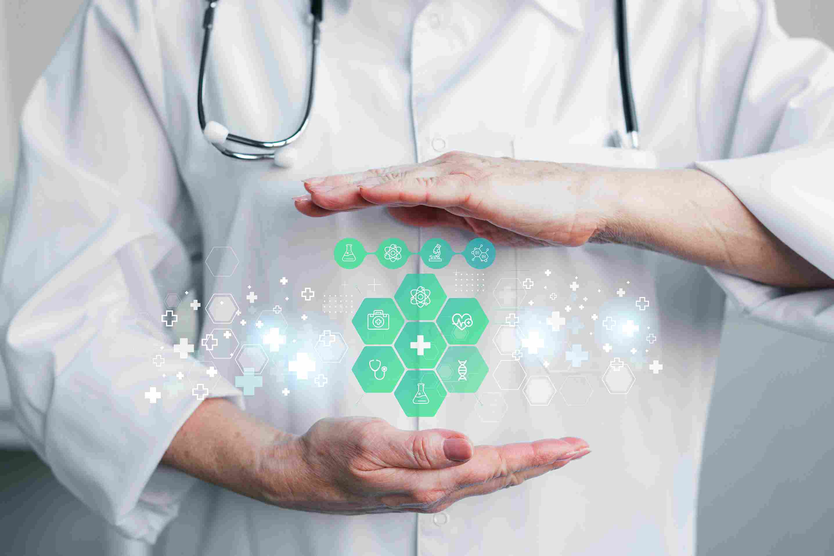 Doctor in a white coat holding virtual medical icons, representing digital healthcare management.