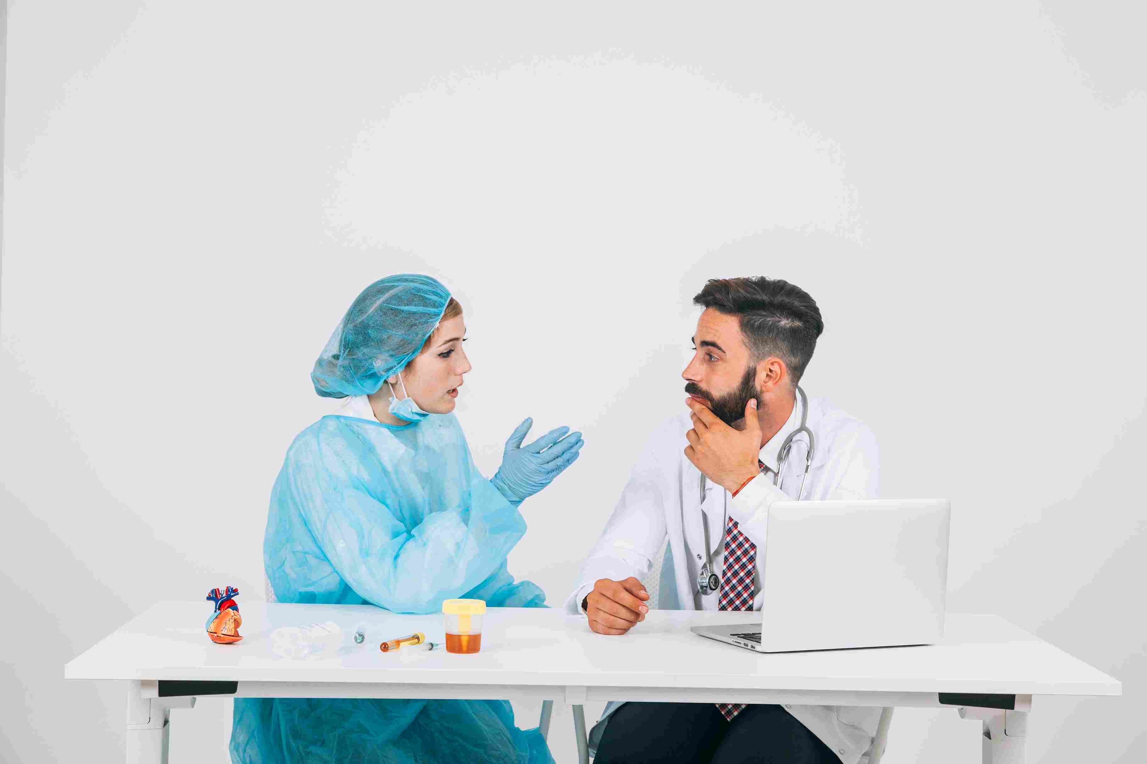 Doctors discussing medical strategies in a hospital office, representing staff readiness and collaboration in adopting hospital management systems