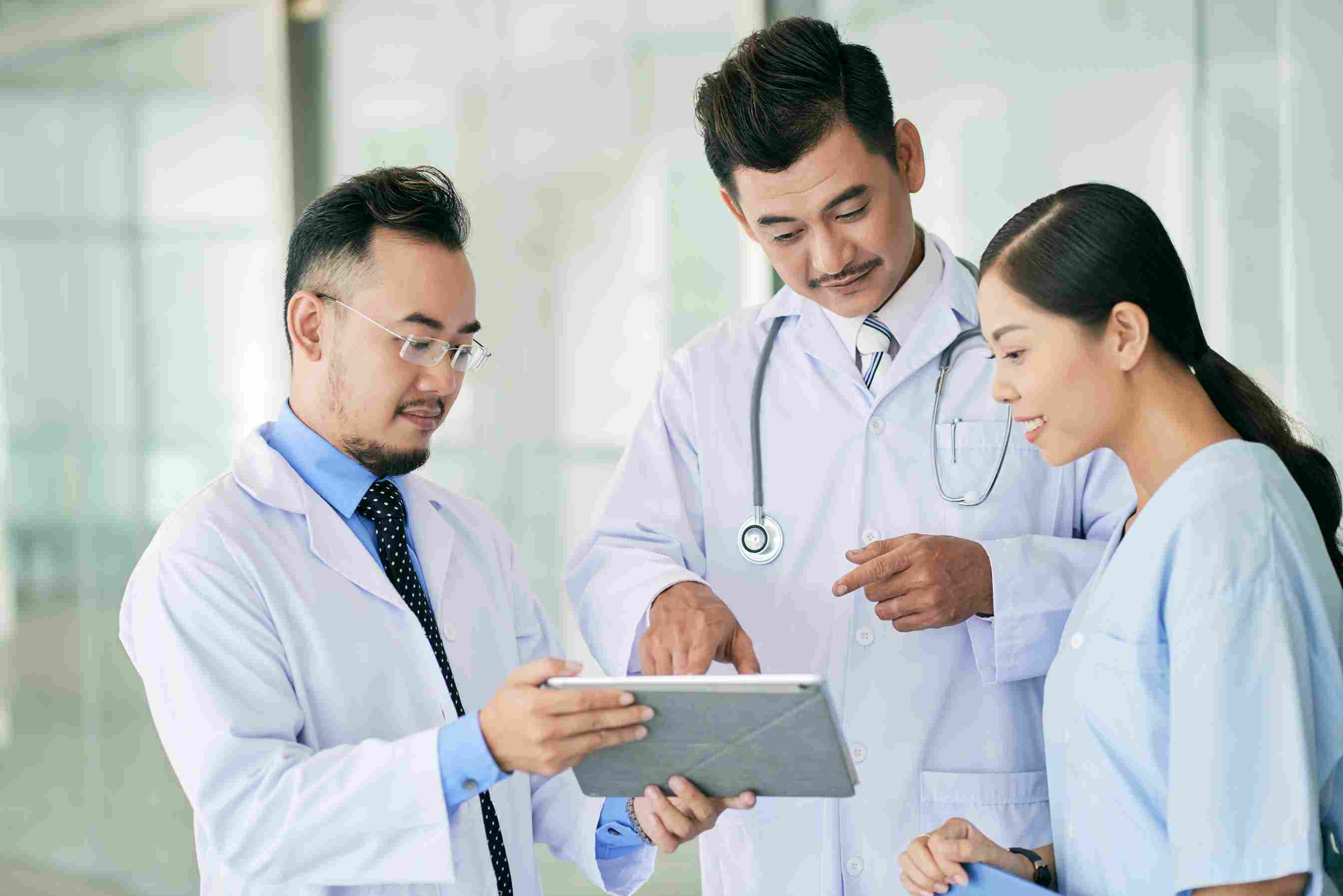 Healthcare professionals in Indonesia discussing patient medical history using hospital