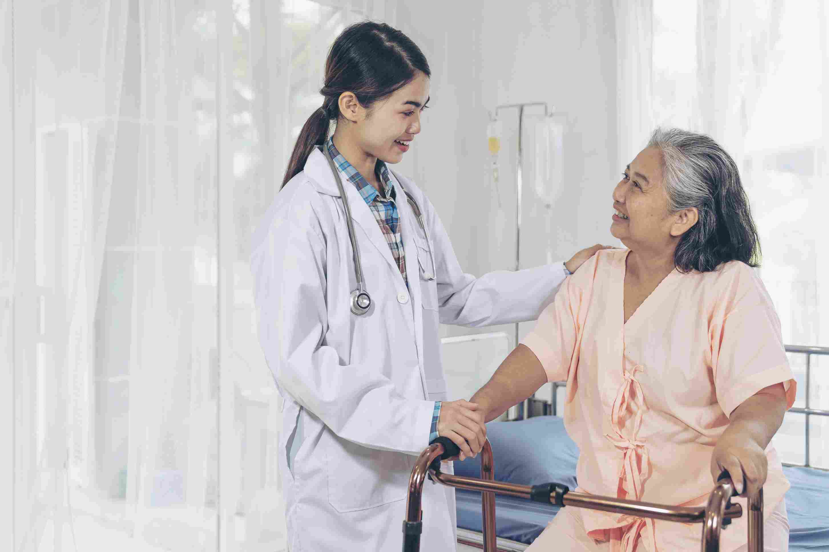 Doctor comforting an elderly woman at her hospital bed, showing quality inpatient care supported by PhilHealth benefits