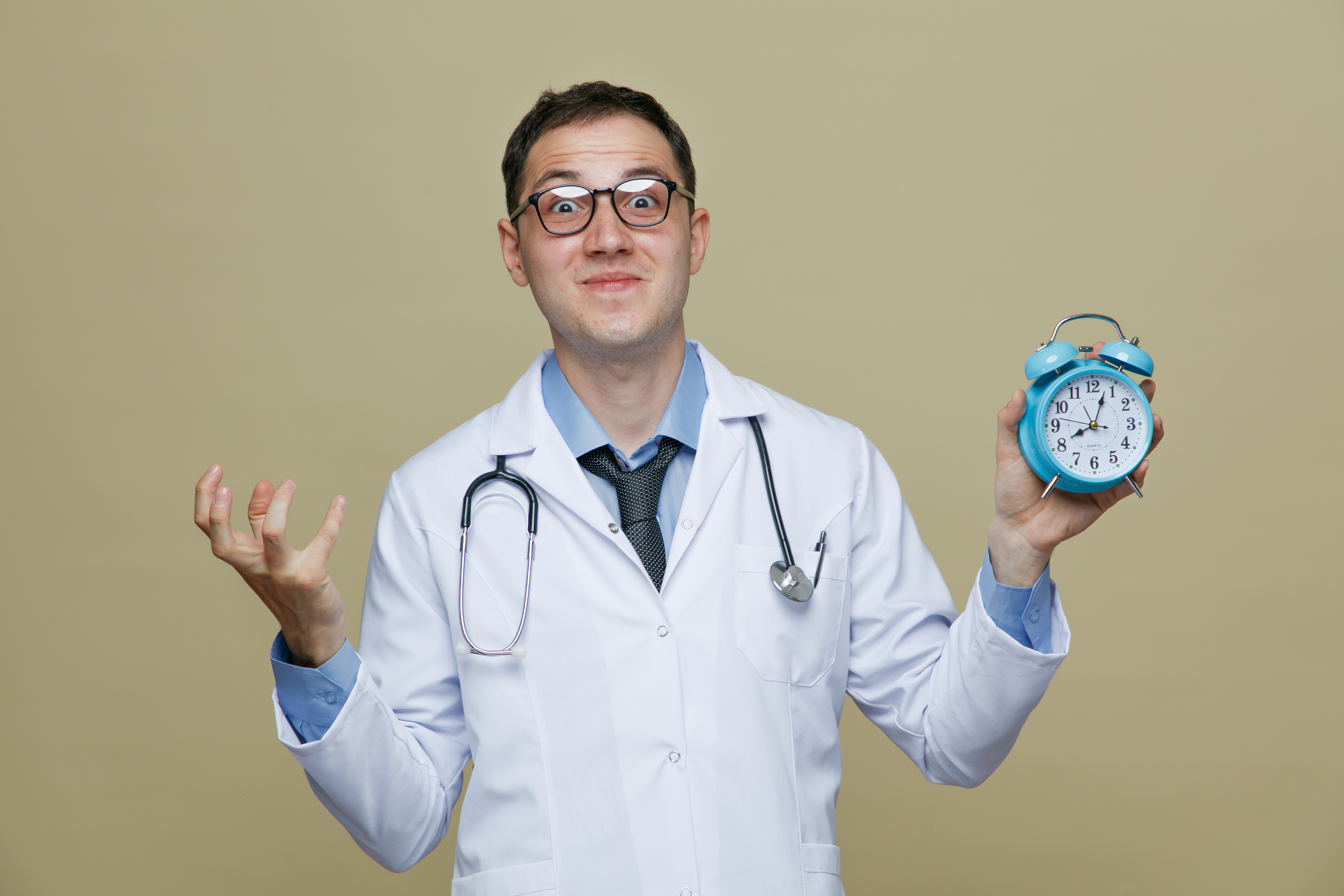 Doctor in white coat holding a clock to illustrate how hospital workflow visibility can reduce patient wait times and improve efficiency