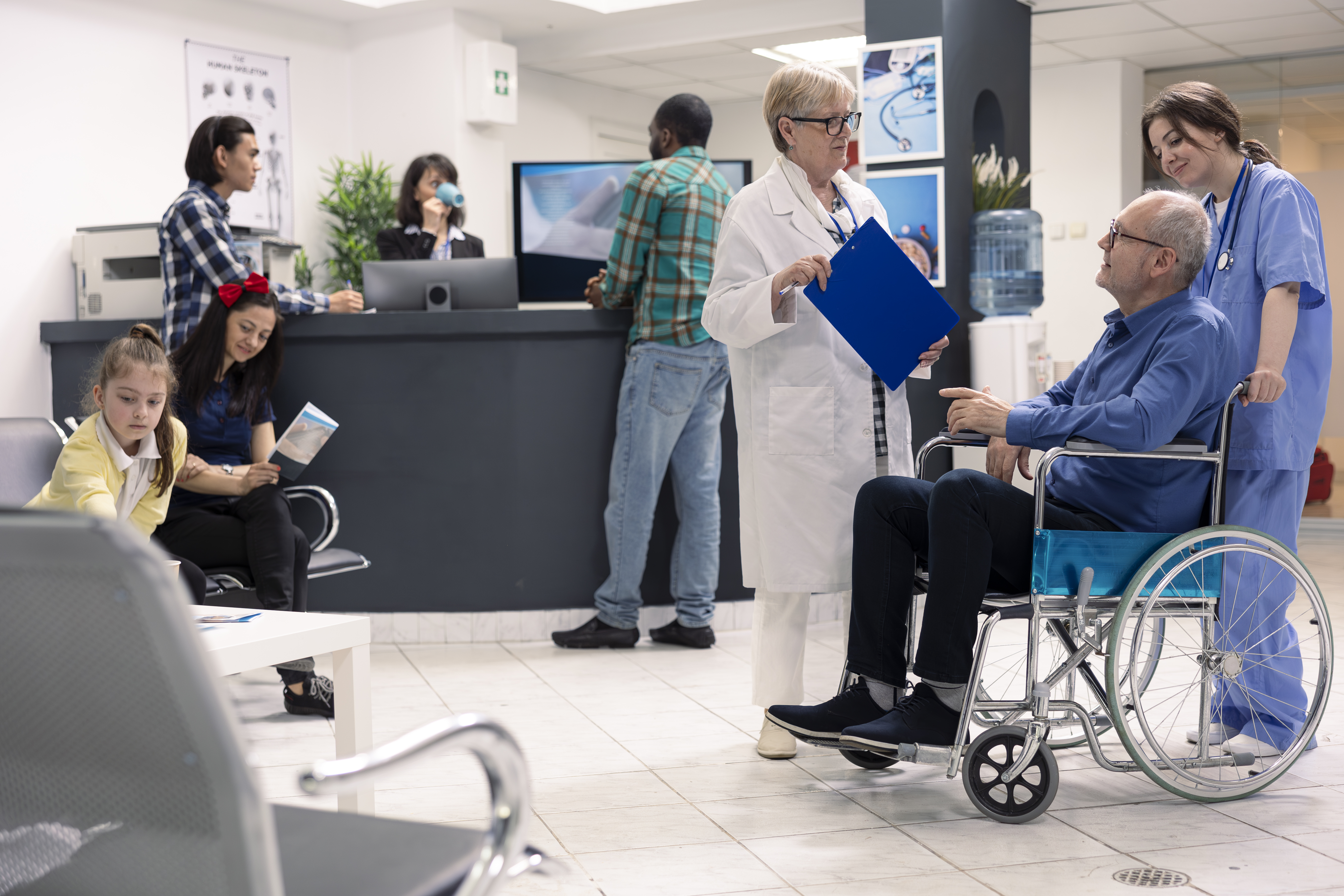 Elderly man in wheelchair attended by nurse and doctor at hospital desk, surrounded by medical charts and attentive staff in a welcoming clinic setting