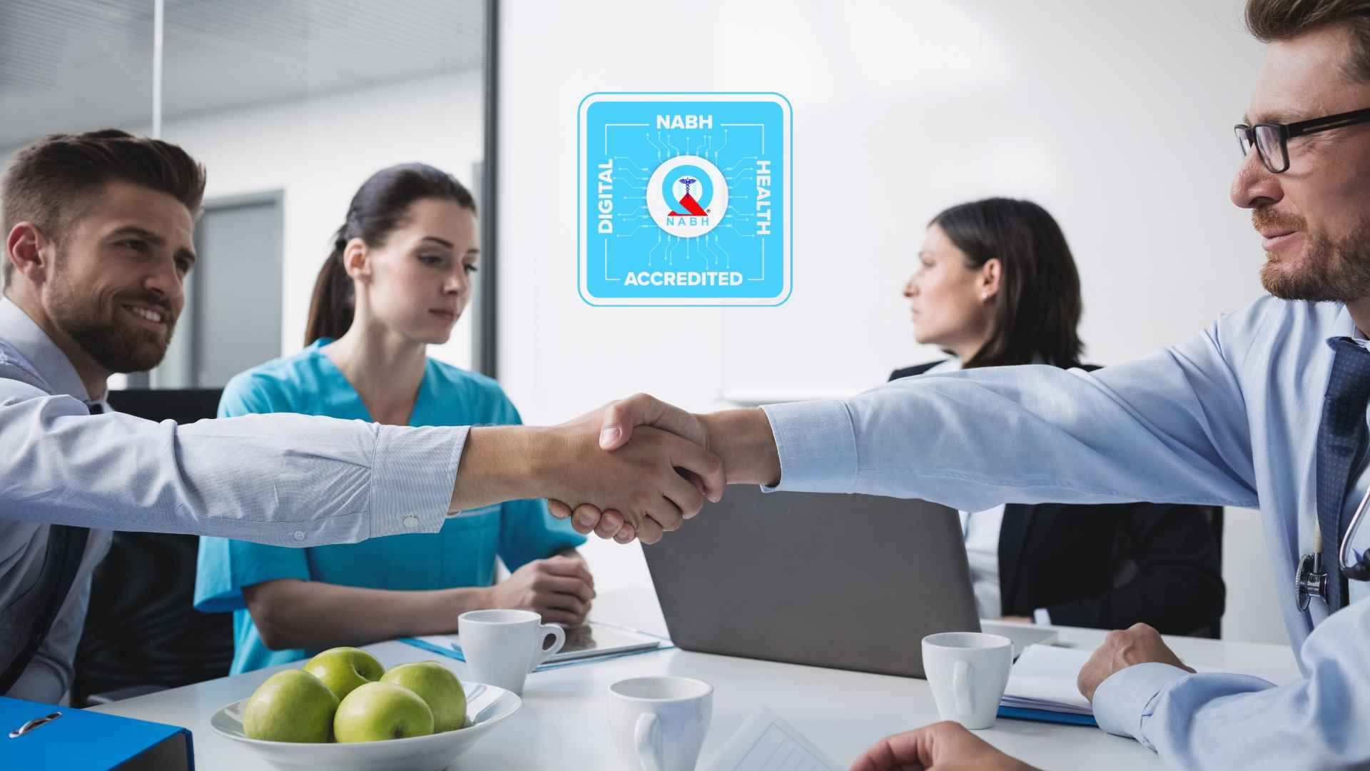 A hospital administrator and a doctor shaking hands across a meeting table with colleagues present in the background, representing a private Indian hospital finalising its digital infrastructure partnership to support NABH 6th Edition accreditation requirements including patient records, audit trails, and medication management compliance